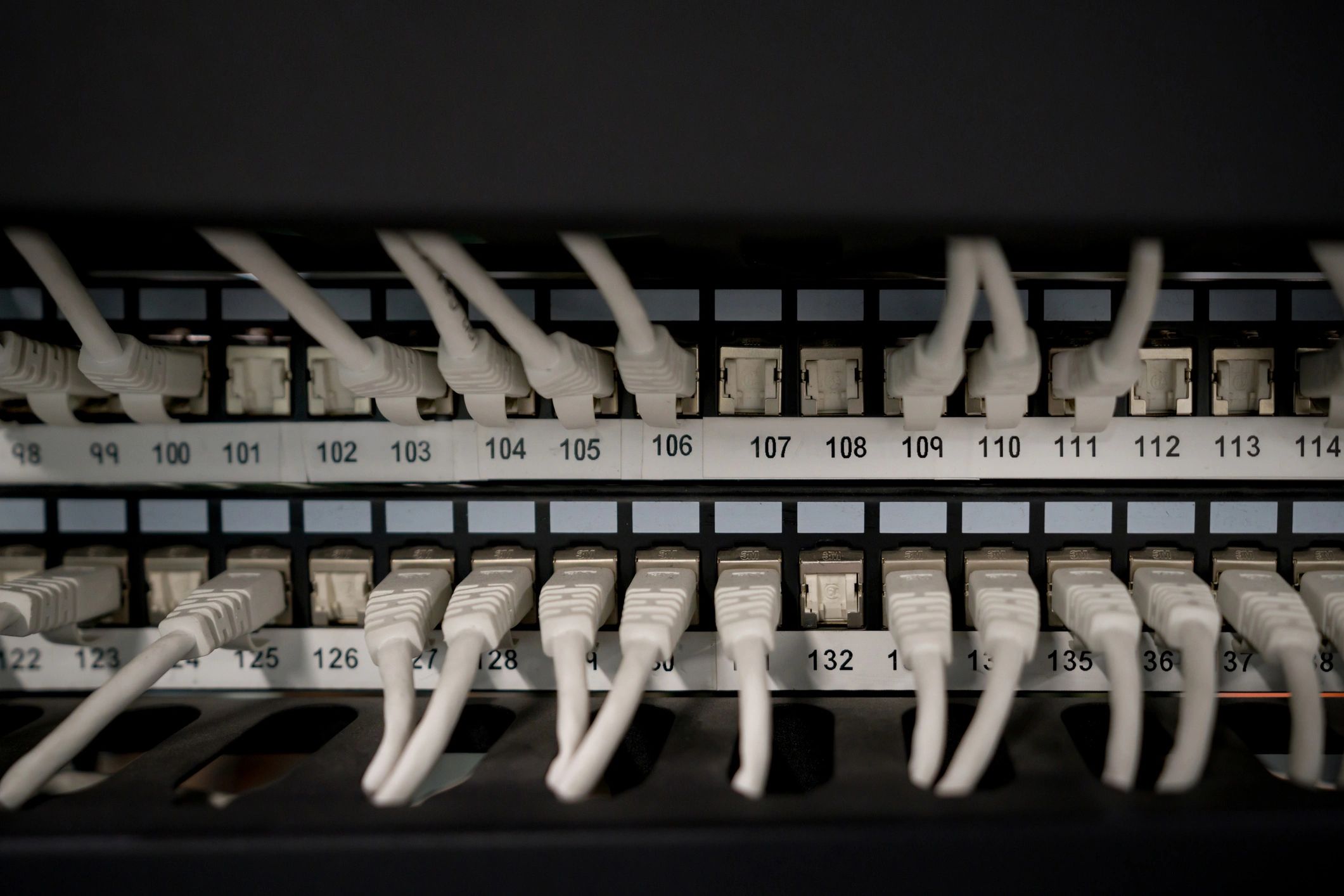 Patch panel with ethernet cables in a network rack