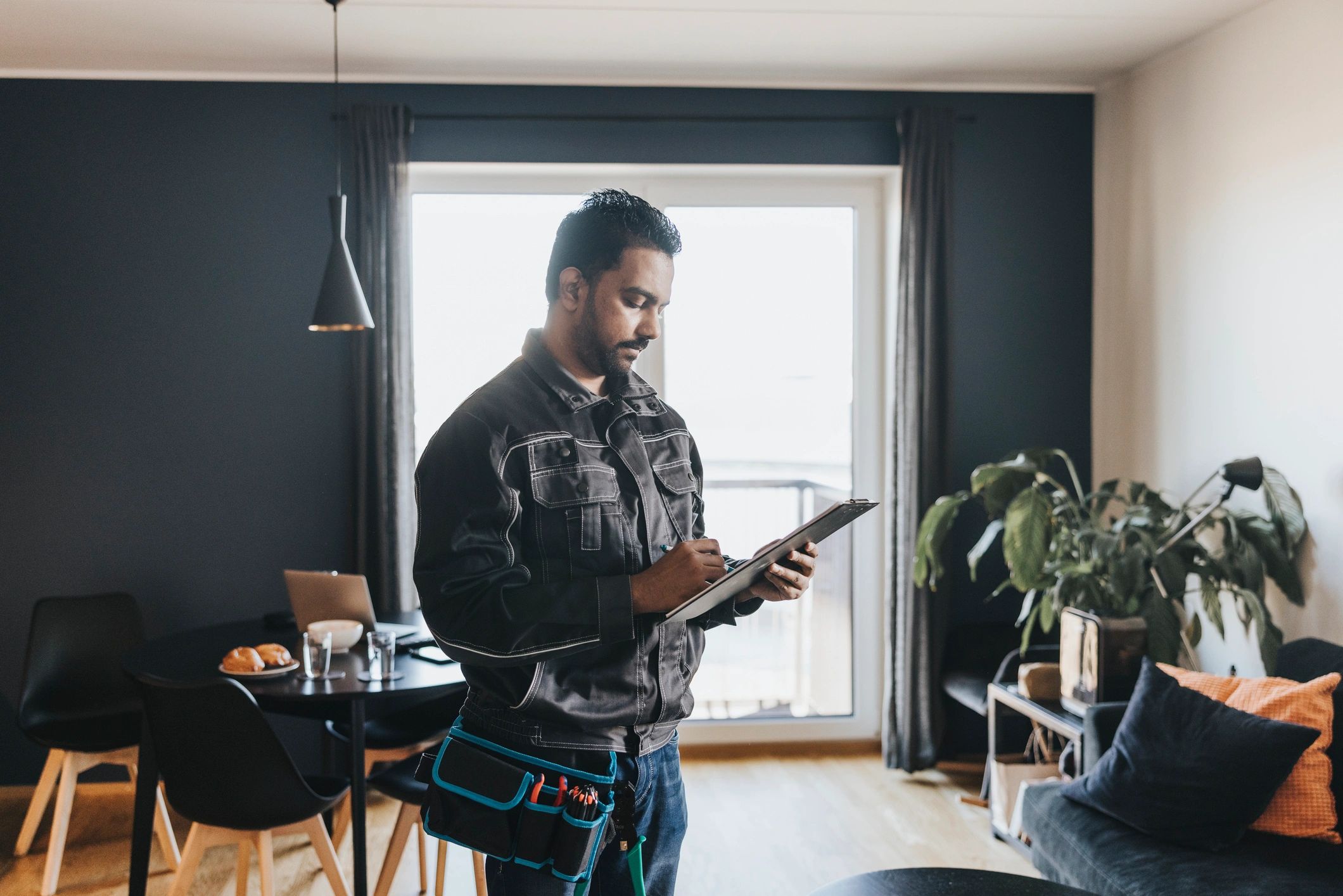 Technician reviewing a job list at a home